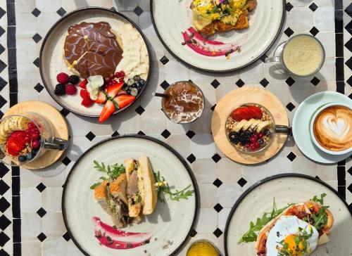 a group of plates of food on a table at Comfy Studios Hotel in Benalmádena