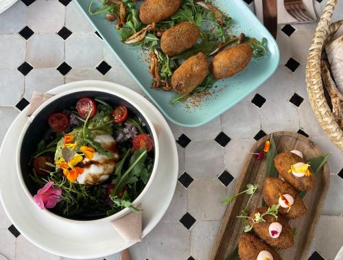a table with a bowl of food and two plates of food at Comfy Studios Hotel in Benalmádena