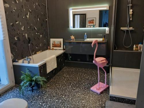 une salle de bain avec un flamant rose au milieu dans l'établissement Parenthèse méditerranéenne - vue mer & terrasse, à La Ciotat