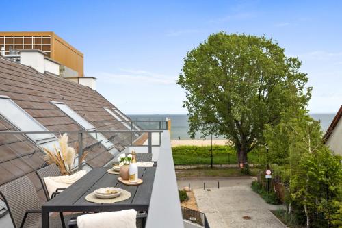 a balcony with a table and a view of the ocean at Rezydencja Merwede Aparthotel - My Rest in Gdańsk