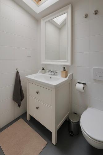 a white bathroom with a sink and a toilet at AL Belém 85 in Lisbon