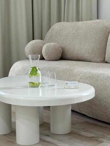 a white coffee table in front of a couch at GOLD Apartment - Lotnisko Katowice-Pyrzowice in Siewierz