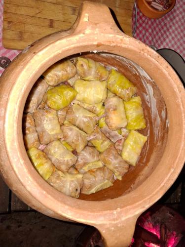 a wooden bowl of food with pineapple in it at Organska Farma Nebesa in Vrmdža