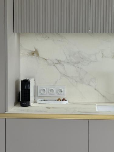 a kitchen with a white counter top with a appliance at GOLD Apartment - Lotnisko Katowice-Pyrzowice in Siewierz