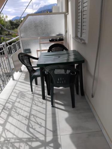 a table and two chairs on a balcony at Rexhos Studios in Himare