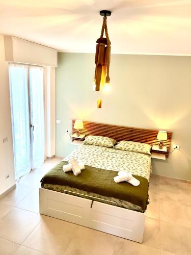 a bedroom with a bed with two towels on it at JungleHouse in Abbadia Lariana
