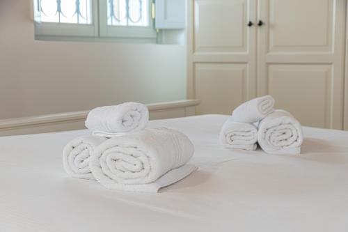 a pile of towels on top of a bed at Atena at Como Duomo in Como