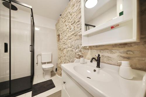 a bathroom with a sink and a shower and a toilet at Vacation House Meri in Blato