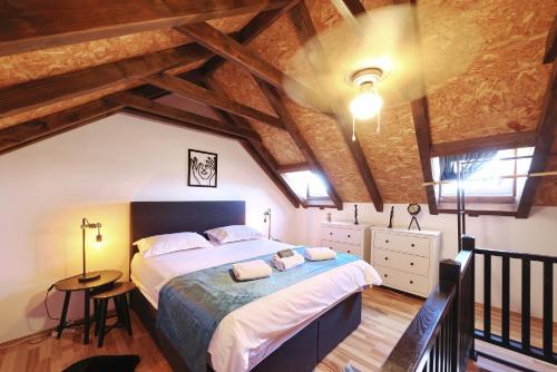 a bedroom with a large bed in a attic at Vacation House Meri in Blato