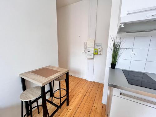 a small kitchen with a small table and a counter at Cocon à Coty in Le Havre