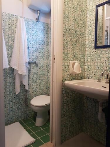 a bathroom with a toilet and a sink at Beachfront villa, right ON SAND! in Cala Liberotto