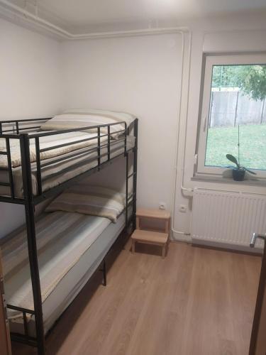 a room with two bunk beds and a window at APARTMA Črnomelj in Črnomelj
