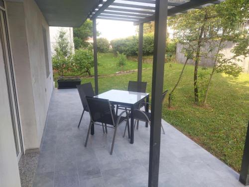 a table and chairs sitting on a patio at APARTMA Črnomelj in Črnomelj