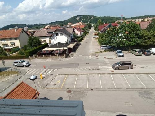 a city street with cars parked in a parking lot at Apartma Golob in Maribor
