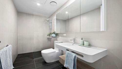 a white bathroom with a sink and a toilet at Richmond Retreat in Melbourne