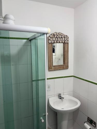 a bathroom with a sink and a glass shower at Villa Buziana 1 in Búzios