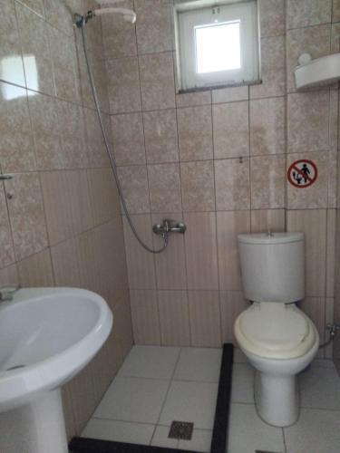a bathroom with a toilet and a sink at Rexhos Studios in Himare