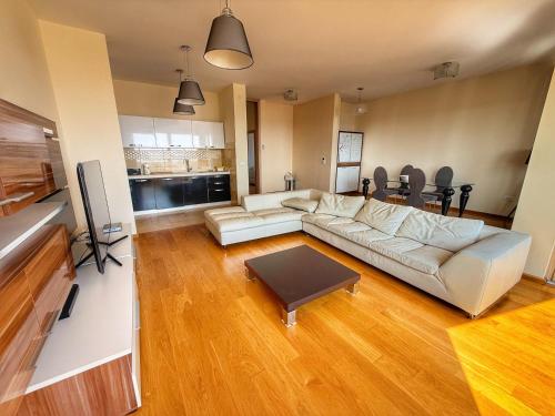 a living room with a couch and a table at Jelena apart Budva in Becici