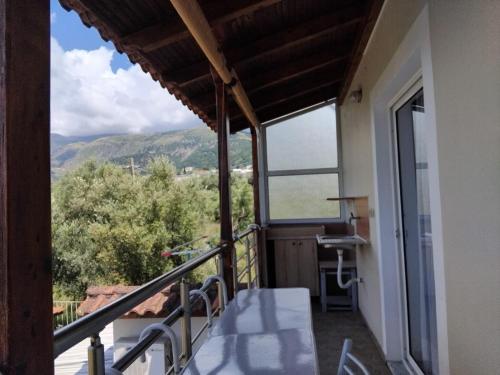 a balcony with a view of the mountains at Rexhos Studios in Himare