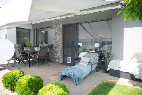 a patio with a table and chairs and glass doors at Prázdninový apartmán Pohoda in Strážnice