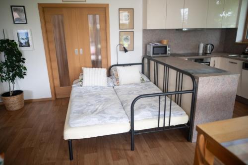 a kitchen with a bed in the middle of a room at Prázdninový apartmán Pohoda in Strážnice