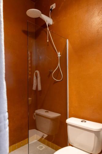 a bathroom with a toilet and a shower stall at O Portalzinho in Paraty