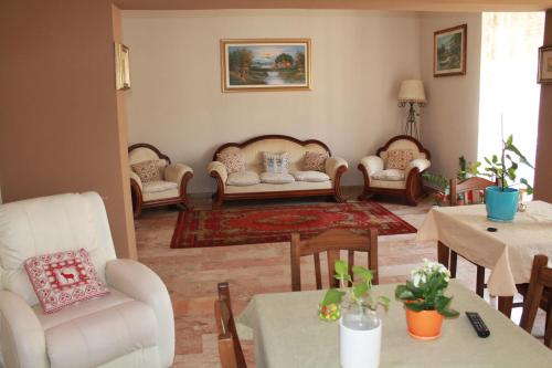 a living room with couches and tables and chairs at B&B Domus Pina in Catania