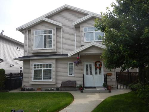 a house with a bench in front of it at Clean and Quiet 2 bdr 2 bthr private entrance entire guests suite near Coquitlam Center mall and skytrain in Coquitlam