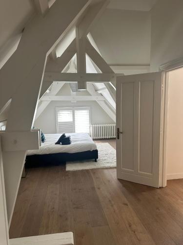 a bedroom with a bed in the attic at Urban Comfort Loft in The Hague
