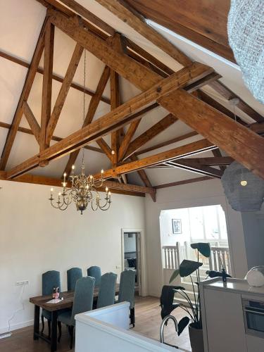a dining room with wooden beams and a table and chairs at Urban Comfort Loft in The Hague