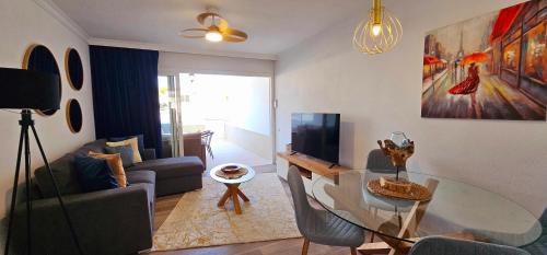 a living room with a table and a living room with a couch at HDFM Collection - Royal Marine Villa in Playa del Ingles