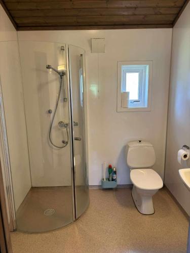 a bathroom with a shower and a toilet and a sink at Skottneset Feriesenter in Barmen