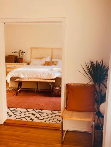 a bedroom with a bed and a chair and a mirror at Summer Home with Private Garden in Klintehamn