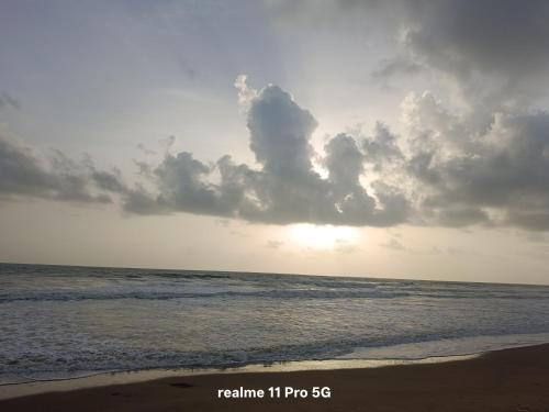 a view of the ocean with a cloudy sky at Srujana Beach Homestay in Gokarn