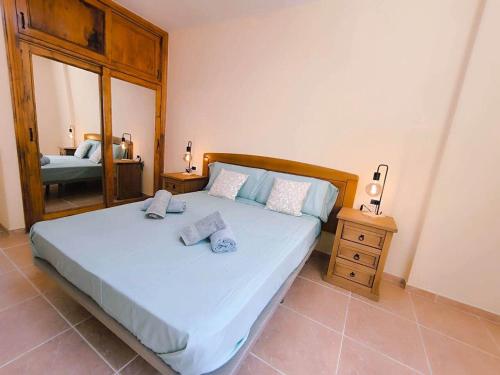 a bedroom with a large bed and a mirror at Casa Elba Candelaria in Candelaria