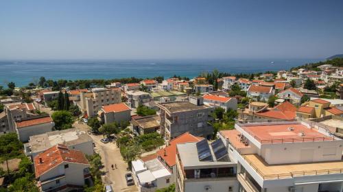 an aerial view of a city with buildings and the ocean at Apart Hotel S Lux in Bar