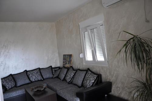 a living room with a couch and a window at Apart Hotel S Lux in Bar