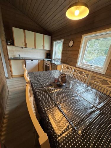 a kitchen with a table with a black and white at Skottneset Feriesenter in Barmen