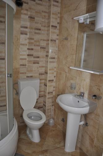a bathroom with a toilet and a sink at Apart Hotel S Lux in Bar