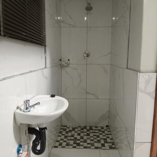 a bathroom with a sink and a shower at Backyard Stay in Pretoria
