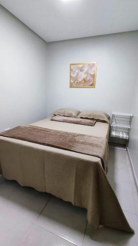 a bedroom with a large bed in a white room at Casa Luz Caruaru - próx feira da sulanca in Caruaru