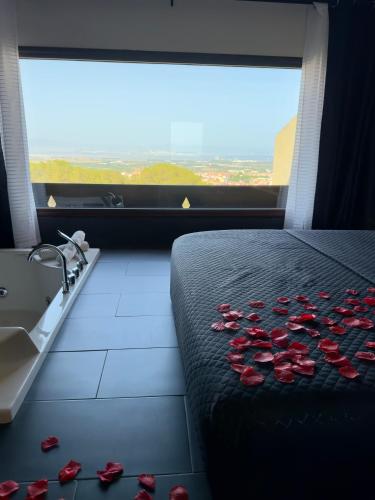 a room with roses on the bed and a sink at Suite 115 - Luxury Rooms in Capoterra