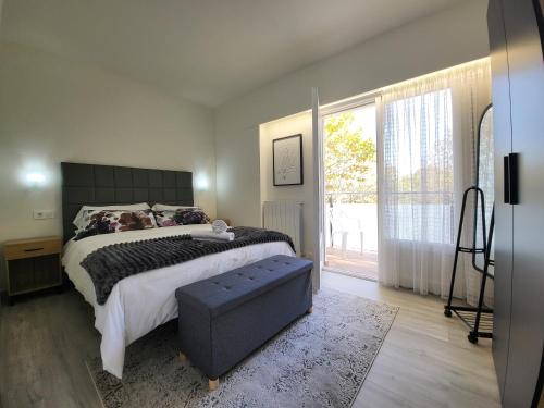 a bedroom with a large bed and a large window at Apartaments Font del Cirerer in Sant Hilari Sacalm