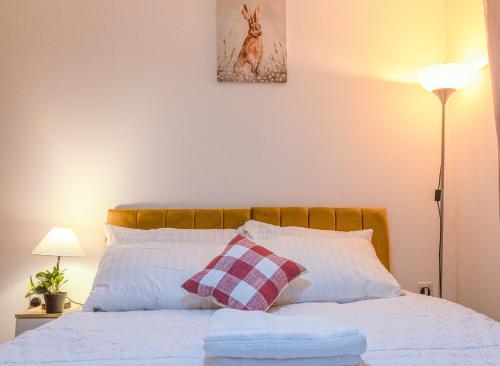a bedroom with a bed with two pillows at Monea Retreat a Modern 2bedroom and 2 bathroom apartment in Coventry in Coventry