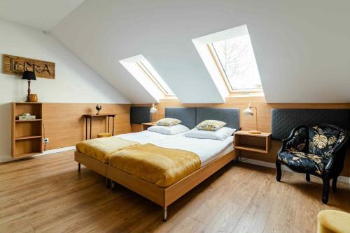 1 dormitorio con 1 cama y 1 silla en el ático en Willa WHITE GLOVE NARTY, en Narty