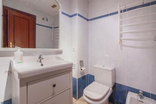 a bathroom with a white toilet and a sink at Apartamento Vista Azul in Costa Ballena