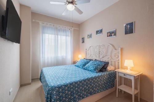 a small bedroom with a bed and a television at Apartamento Vista Azul in Costa Ballena