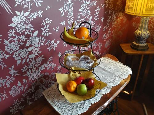 a table with a basket of fruit on a table at The Bissing House in Hays