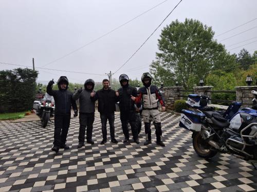 a group of men standing next to a motorcycle at Mont Blanc Hotel in Peshkopi