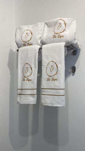 three white towels are hanging on a towel rack at La Lapa in Arrecife